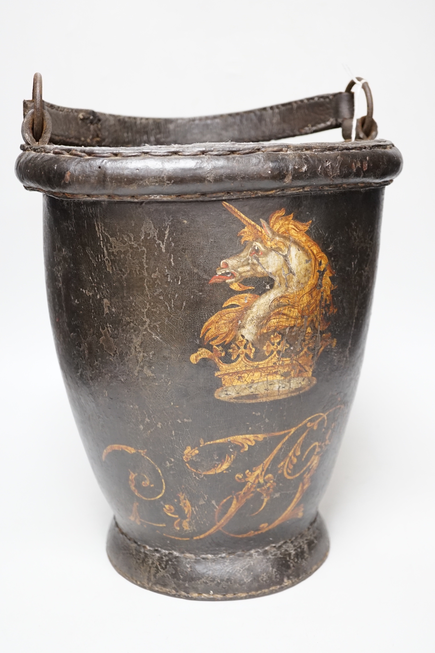 A 19th century leather painted armorial fire bucket, 30cm high